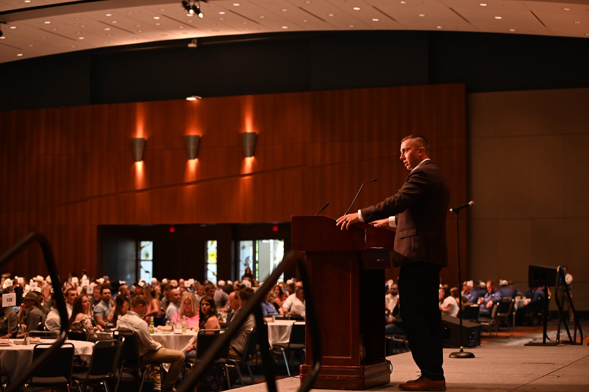 Man speaking at podium during event