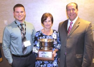 The ACRE Cup goes to Community Electric Cooperative with (from l) staffer Evan Wagonsomer, Board Chairwoman Jeannette Everett and President and CEO Steve Harmon.